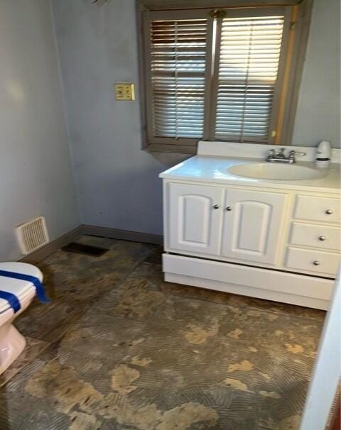 bathroom with vanity and toilet