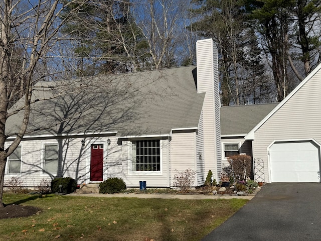 view of front of property with a garage and a front lawn