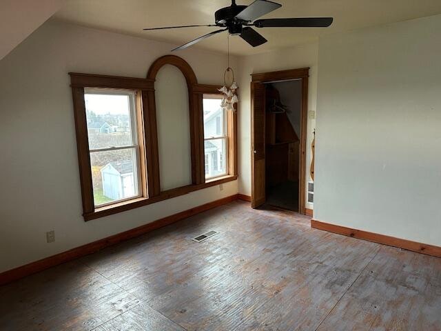 empty room with vaulted ceiling and ceiling fan