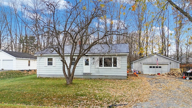 view of front of home with an outbuilding, a garage, and a front lawn