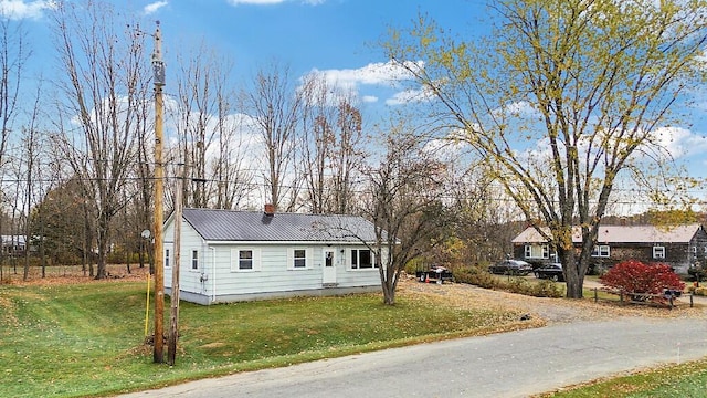 18 Sebasticook Dr, Clinton, ME 04927 - ranch-style house with a front lawn, metal roof, and a chimney