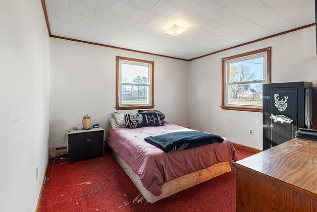 bedroom with dark carpet and crown molding