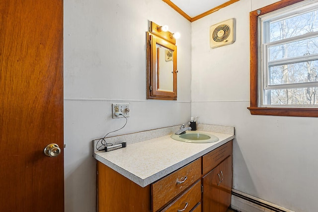 bathroom with baseboard heating, vanity, and crown molding