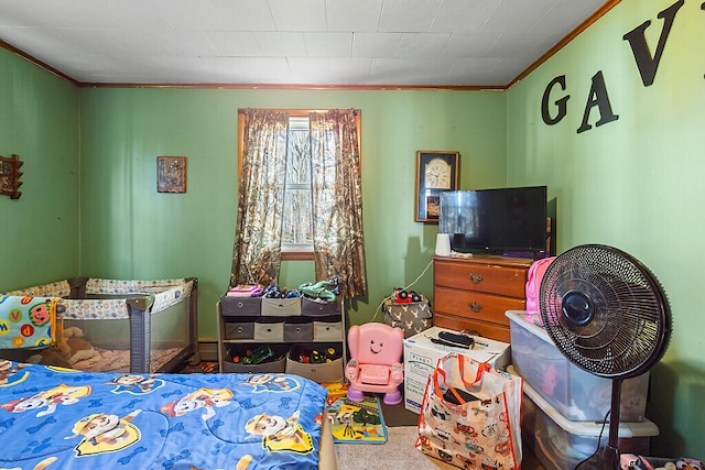 bedroom featuring ornamental molding and carpet