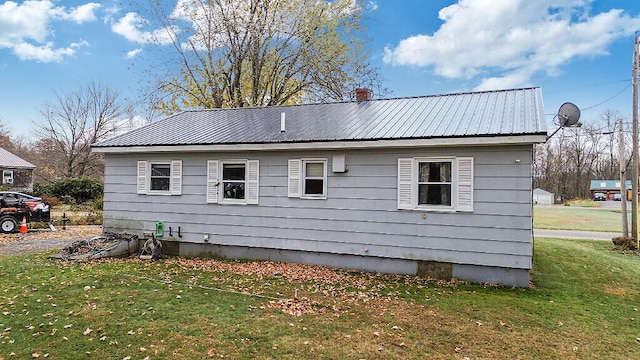 view of property exterior featuring a lawn