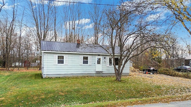 18 Sebasticook Dr, Clinton, ME 04927 - ranch-style home with metal roof, a front yard, and a chimney