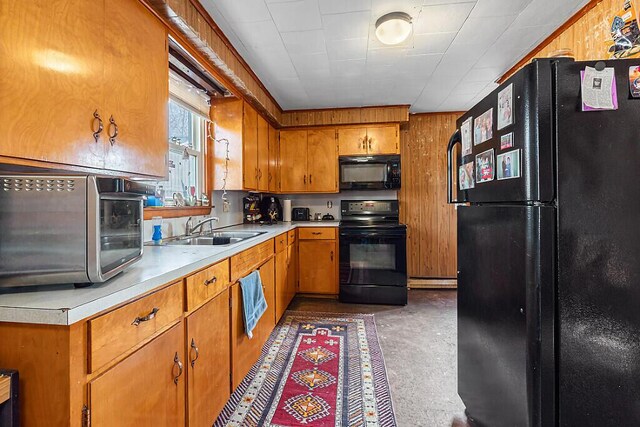 18 Sebasticook Dr, Clinton, ME 04927 - kitchen with black appliances, a sink, light countertops, concrete floors, and brown cabinets