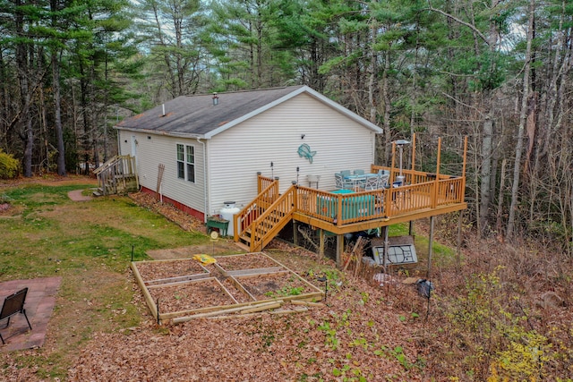 back of house with a lawn and a wooden deck