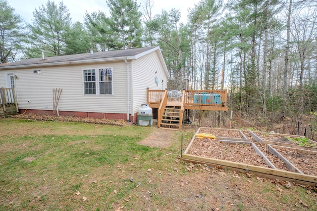 back of house featuring a yard and a wooden deck