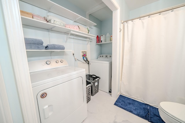 washroom featuring washer and clothes dryer