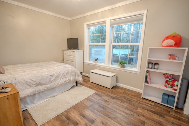 bedroom featuring hardwood / wood-style floors and crown molding