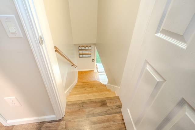 stairs featuring wood-type flooring