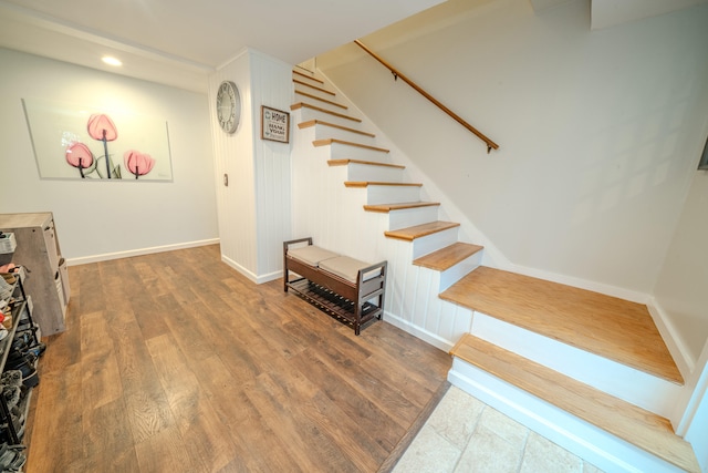 staircase with hardwood / wood-style floors