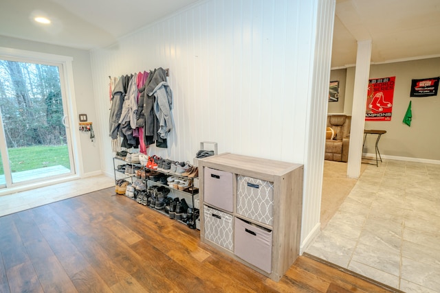 mudroom with crown molding and hardwood / wood-style flooring