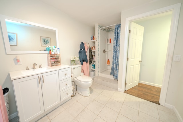 bathroom featuring a shower with shower curtain, wood-type flooring, vanity, and toilet