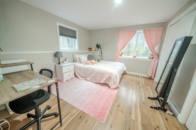 bedroom featuring multiple windows and light wood-type flooring