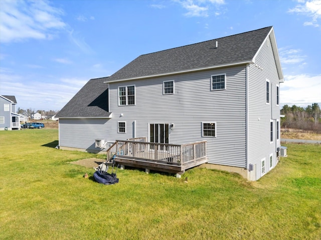 back of house with a deck and a yard