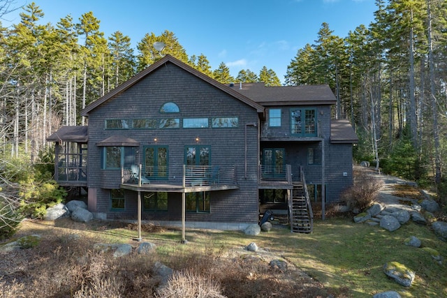 back of house with a deck and a lawn