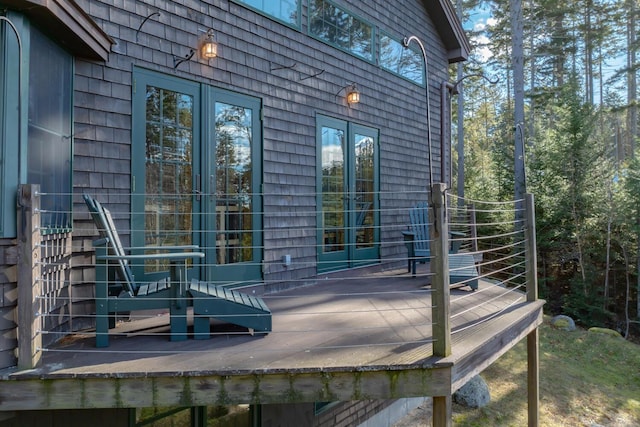 view of property exterior with a wooden deck and french doors