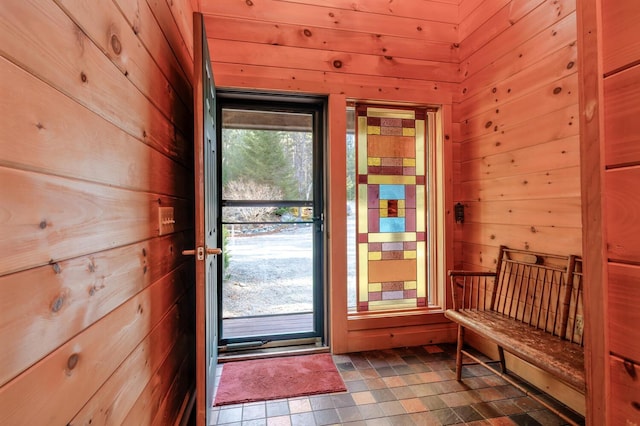 entryway with wooden walls