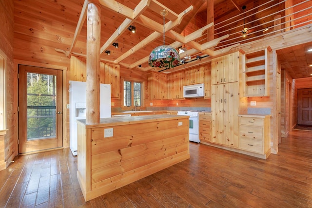 kitchen with wood walls, light brown cabinetry, white appliances, and hardwood / wood-style flooring