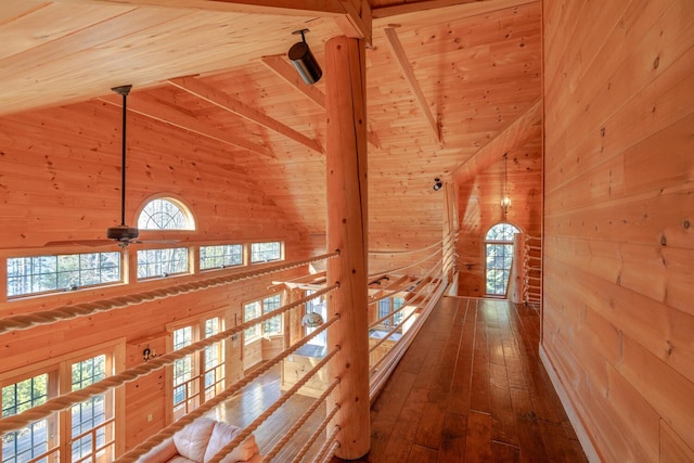 hallway with wood ceiling, wood walls, beamed ceiling, and wood-type flooring