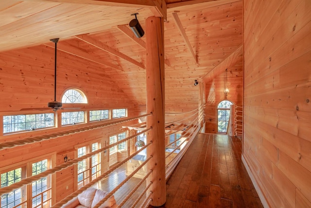 1700 Tremont Rd, Tremont, ME 04674 - hallway with wooden walls, high vaulted ceiling, healthy amount of natural light, a wood ceiling with exposed beams, and hardwood / wood-style floors