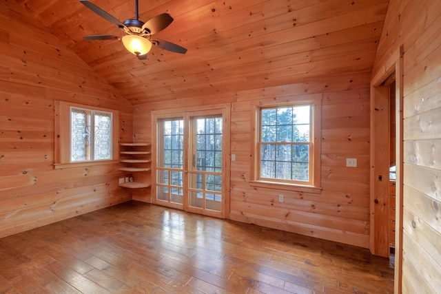 unfurnished room featuring hardwood / wood-style flooring, wood walls, and wood ceiling