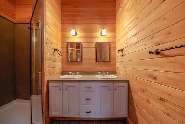 bathroom featuring vanity, wood walls, and walk in shower