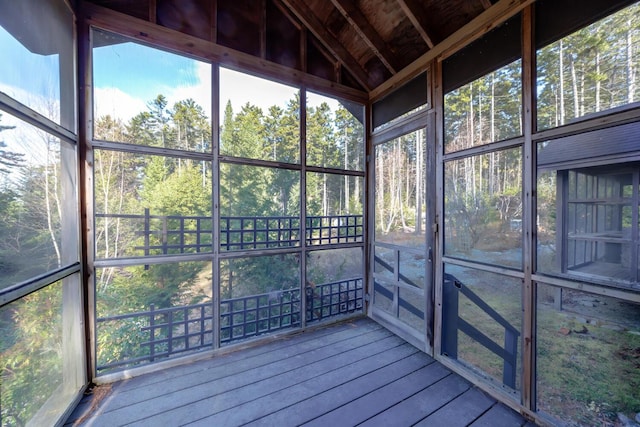 unfurnished sunroom with lofted ceiling