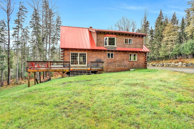 658 Mingo Loop Rd, Rangeley, ME 04970 - back of house featuring log siding, a wooden deck, a lawn, metal roof, and a standing seam roof