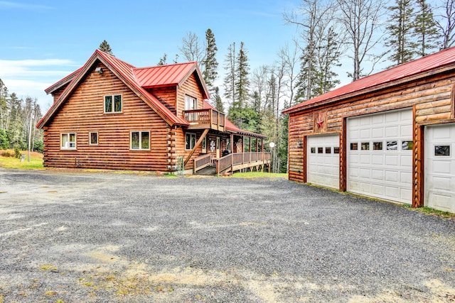 658 Mingo Loop Rd, Rangeley, ME 04970 - view of side of home with log siding, metal roof, and a deck