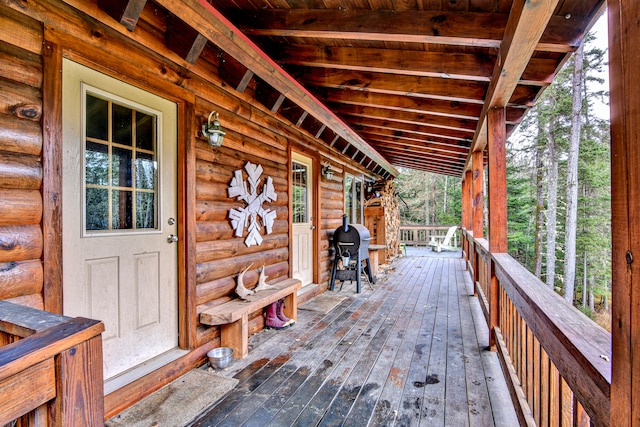 wooden terrace with a porch and grilling area