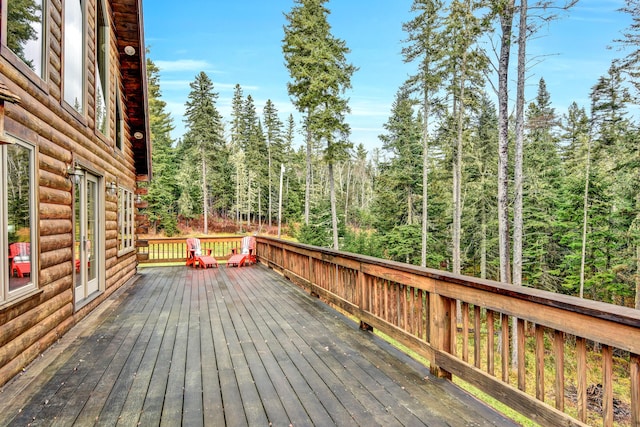 658 Mingo Loop Rd, Rangeley, ME 04970 - wooden deck with a forest view