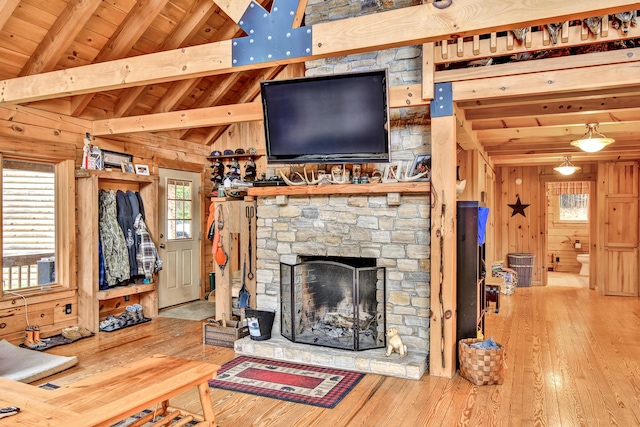 658 Mingo Loop Rd, Rangeley, ME 04970 - unfurnished living room with wooden ceiling, hardwood / wood-style flooring, wooden walls, and a fireplace