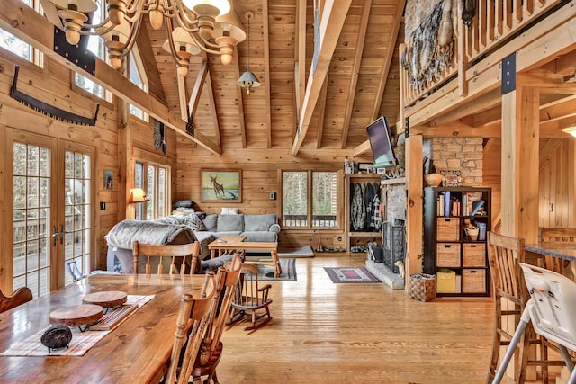 658 Mingo Loop Rd, Rangeley, ME 04970 - dining area featuring wood walls, high vaulted ceiling, wooden ceiling with exposed beams, wood finished floors, and french doors