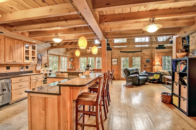 kitchen featuring beamed ceiling, light wood-type flooring, wooden ceiling, and wood walls