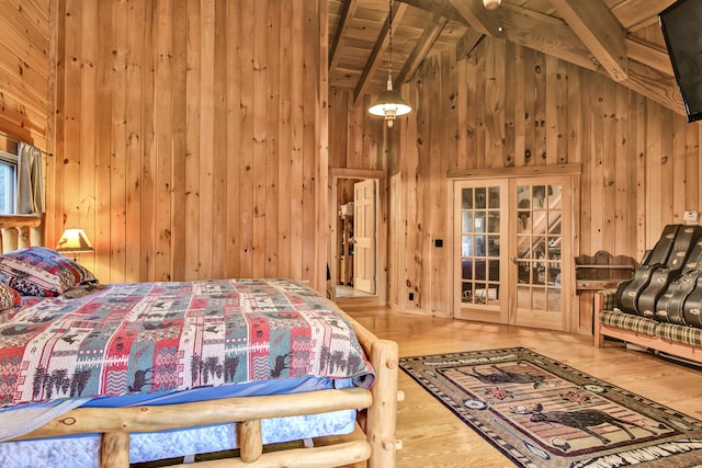 bedroom with wood walls, french doors, hardwood / wood-style flooring, beamed ceiling, and wood ceiling