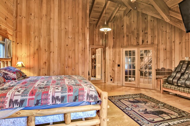 658 Mingo Loop Rd, Rangeley, ME 04970 - bedroom with wood walls, wood finished floors, wood ceiling with exposed beams, high vaulted ceiling, and french doors