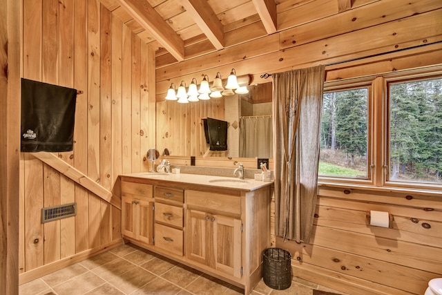 bathroom with beam ceiling, wood walls, tile patterned flooring, and wood ceiling