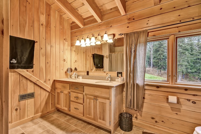 658 Mingo Loop Rd, Rangeley, ME 04970 - full bath featuring wood walls, double vanity, tile patterned floors, wood ceiling with exposed beams, and curtained shower