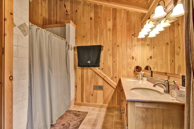 bathroom with tile patterned flooring, vanity, walk in shower, and wood walls