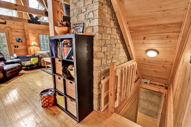 interior space with wood walls, wooden ceiling, and hardwood / wood-style flooring