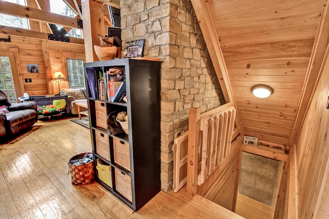 658 Mingo Loop Rd, Rangeley, ME 04970 - stairway featuring hardwood / wood-style floors, wooden walls, and vaulted ceiling