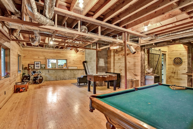 playroom featuring a barn door, wooden walls, billiards, and hardwood / wood-style flooring