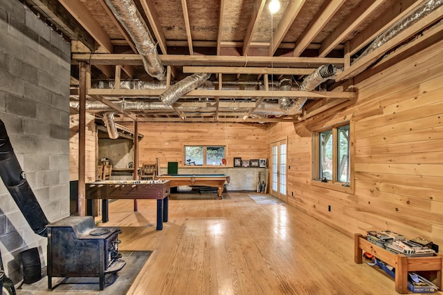 658 Mingo Loop Rd, Rangeley, ME 04970 - unfurnished living room with wooden walls, billiards table, hardwood / wood-style floors, and a wood stove