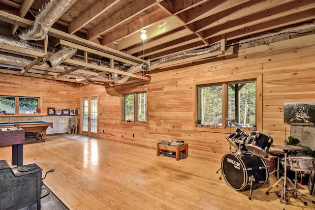 recreation room featuring wood walls, hardwood / wood-style floors, french doors, and billiards