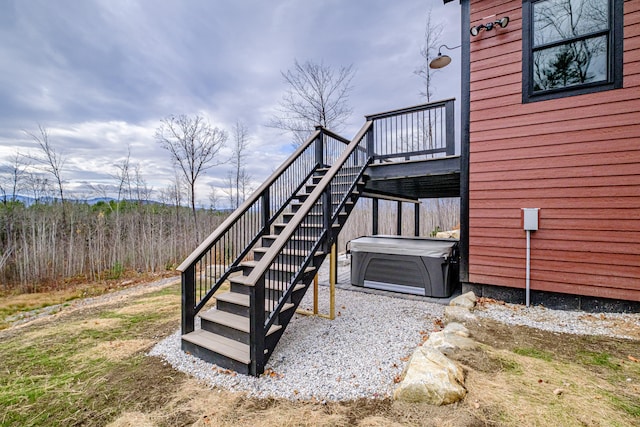 exterior space featuring a hot tub and a deck