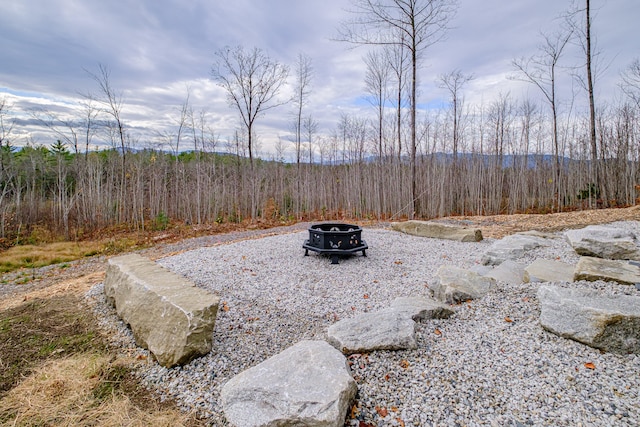 view of yard with an outdoor fire pit