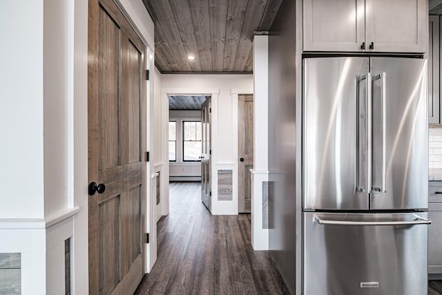 kitchen featuring baseboard heating, dark wood-type flooring, wooden ceiling, and high end refrigerator